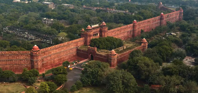 Aerial view of the historic Red Fort massive red sandstone walls and turrets in Delhi.