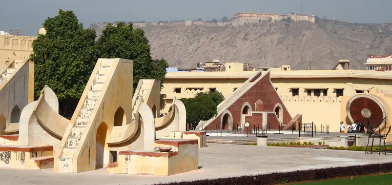 Astronomical instruments of Jantar Mantar observatory in Jaipur with a fort in the background