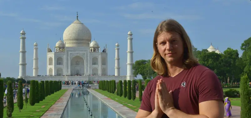 tourist posing in front of taj mahal