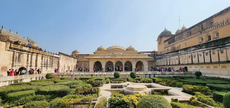 Courtyard and landscaped gardens of Amber Fort with visitors