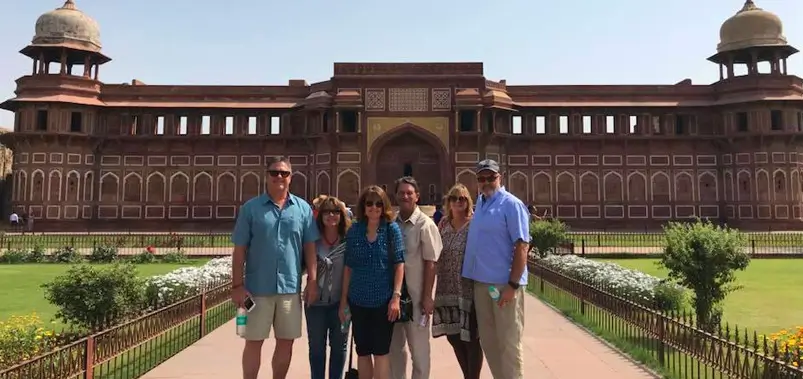Group of international tourists visiting a historic red sandstone fort in India