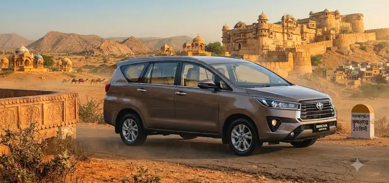 Modern touring vehicle past Rajasthani fort and desert