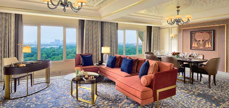 Elegant and spacious five-star hotel suite living area with luxury furnishings and city